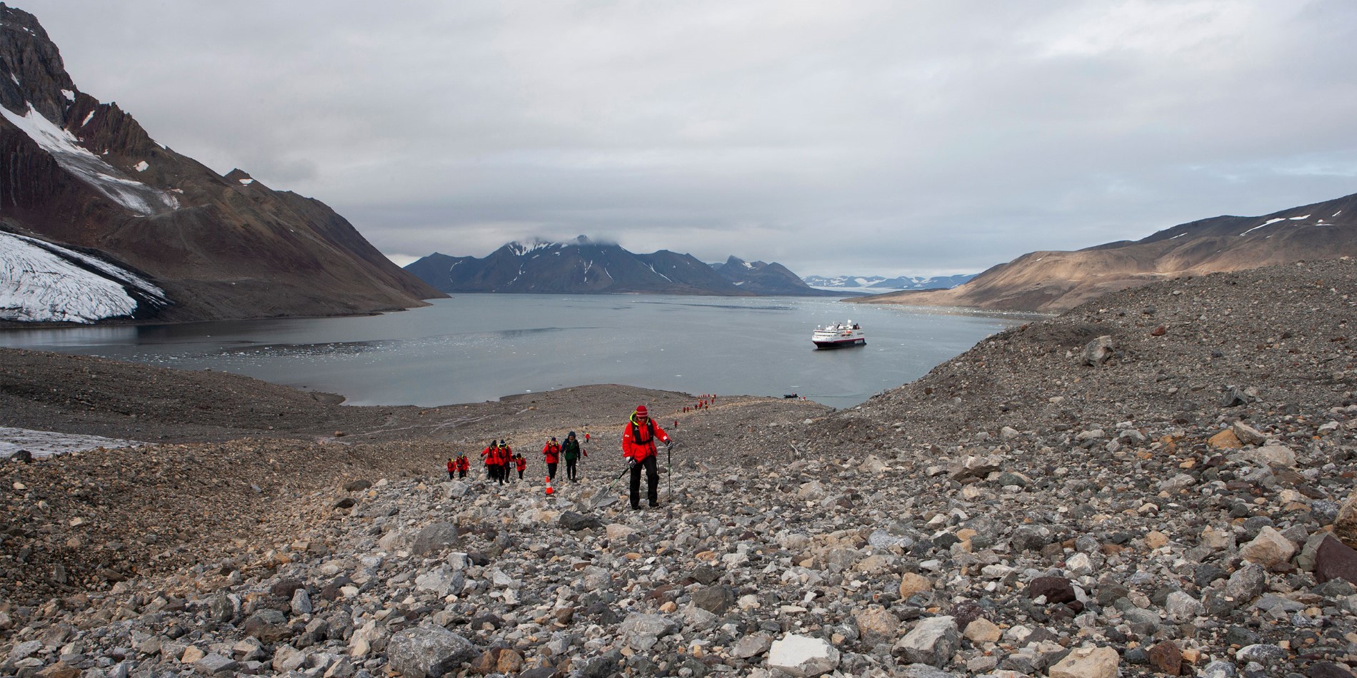 Exterior view of MS Spitsbergen beyond Norwegian mountains - Photo Credit: Lise Dreistel